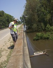 Scientist taking samples of flooded rivers.